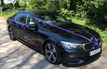 Wedding Car in Brighton with purple ribbons in the countryside